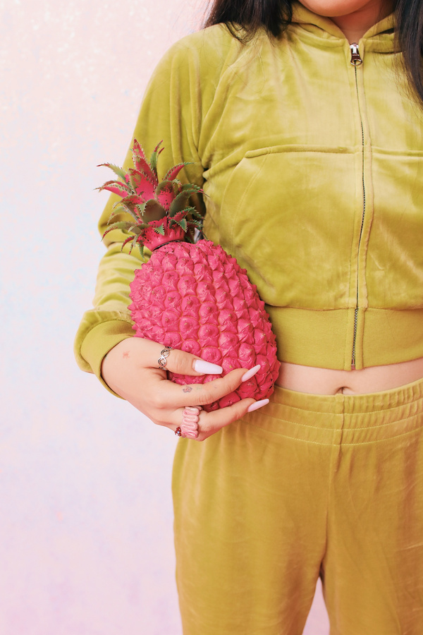 Woman in Green Suede Loungewear with Pink Pineapple